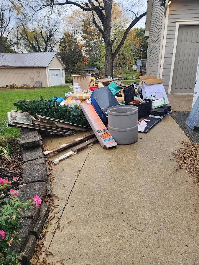 Dumpster being loaded with debris for Estate Cleanout Dumpster Rental in Alfred